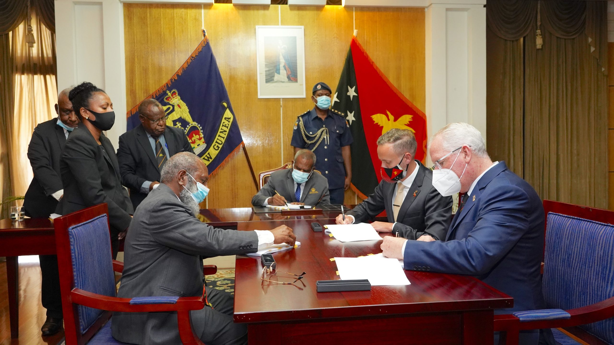 Image Caption: (From Left to Right) Petroleum Minister, Hon. Kerenga Kua; Governor General, Grand Chief Sir Bob Dadae; Chairman of Esso PNG P’nyang Limited, Peter Larden; and SANTOS Chief Operating Officer – Upstream Oil & Gas, Brett Darley, signing the P’nyang Gas Agreement at Government House. PHOTO: ExxonMobil PNG