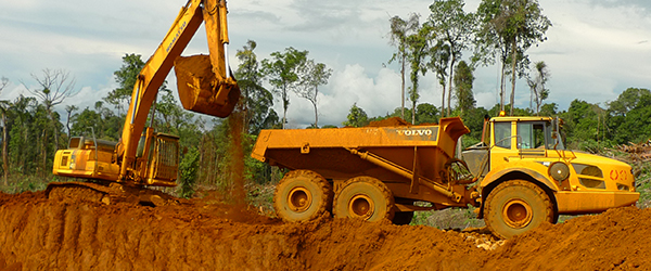 An excavator loading a dump truck at Ramu NiCo’s Kurumbukari mine