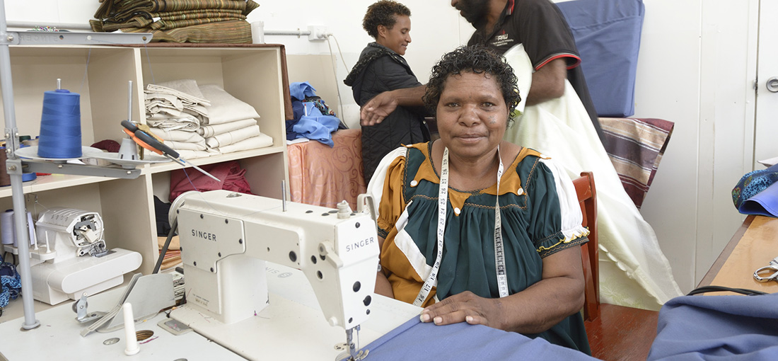 A woman at a sewing machine in a community livelihood workshop
