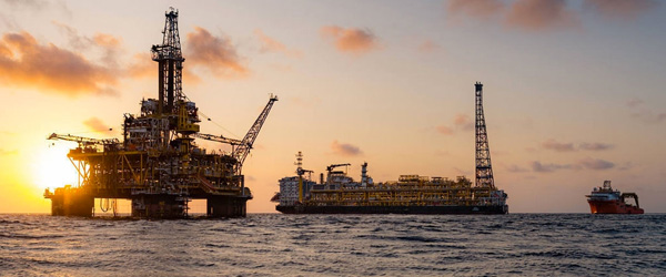 An offshore drilling platform at sunset